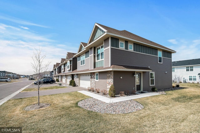 2173 Heron Ct, Lino Lakes, MN 55038 - exterior space with board and batten siding, an attached garage, a lawn, and driveway