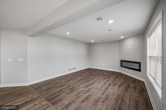 2173 Heron Ct, Lino Lakes, MN 55038 - unfurnished living room featuring dark wood-style flooring, visible vents, and recessed lighting