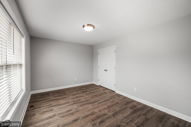 2173 Heron Ct, Lino Lakes, MN 55038 - spare room with baseboards, wood finished floors, and visible vents