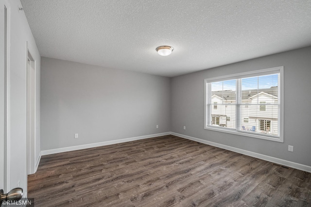 2173 Heron Ct, Lino Lakes, MN 55038 - empty room with baseboards, dark wood-style flooring, a textured ceiling, and visible vents