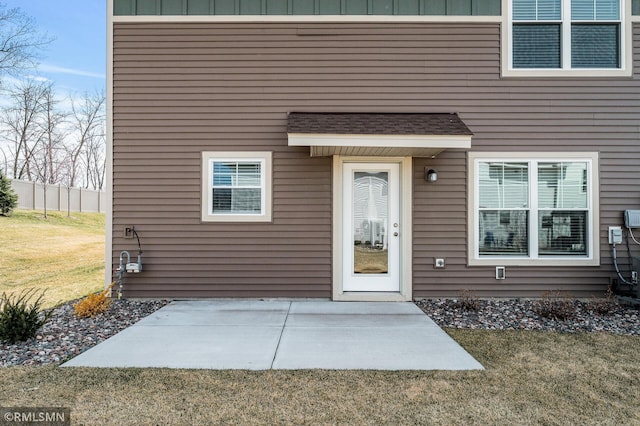 2173 Heron Ct, Lino Lakes, MN 55038 - doorway to property with board and batten siding, a lawn, and a patio area