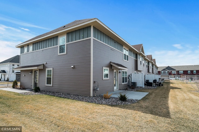 2173 Heron Ct, Lino Lakes, MN 55038 - back of house with cooling unit, fence, a lawn, board and batten siding, and a patio