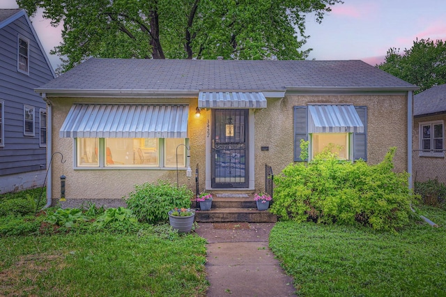3427 Upton Ave N, Minneapolis, MN 55412 - bungalow-style house featuring stucco siding and roof with shingles