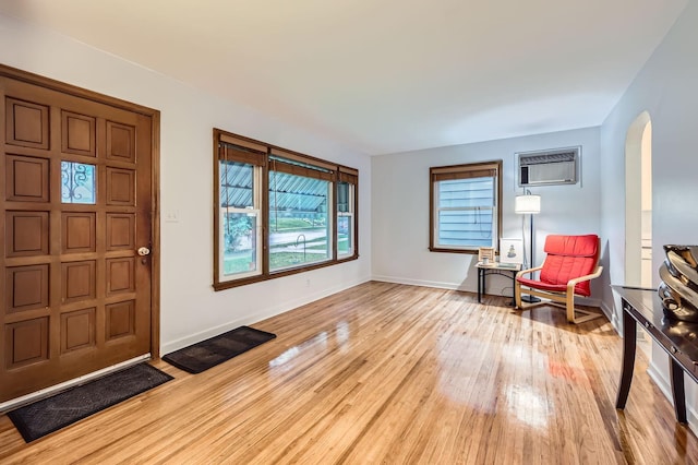 3427 Upton Ave N, Minneapolis, MN 55412 - foyer featuring arched walkways, light wood-type flooring, baseboards, and a wall mounted air conditioner