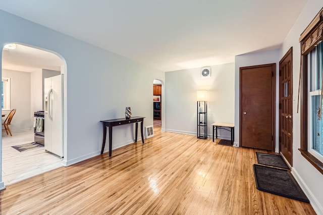 3427 Upton Ave N, Minneapolis, MN 55412 - empty room featuring arched walkways, light wood-type flooring, and baseboards