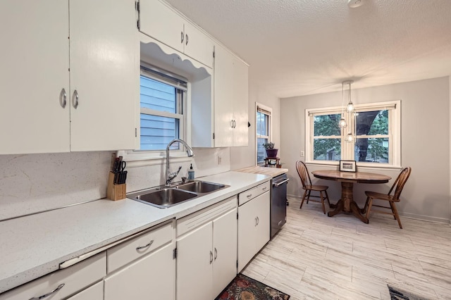 3427 Upton Ave N, Minneapolis, MN 55412 - kitchen featuring a sink, light countertops, white cabinets, plenty of natural light, and a textured ceiling