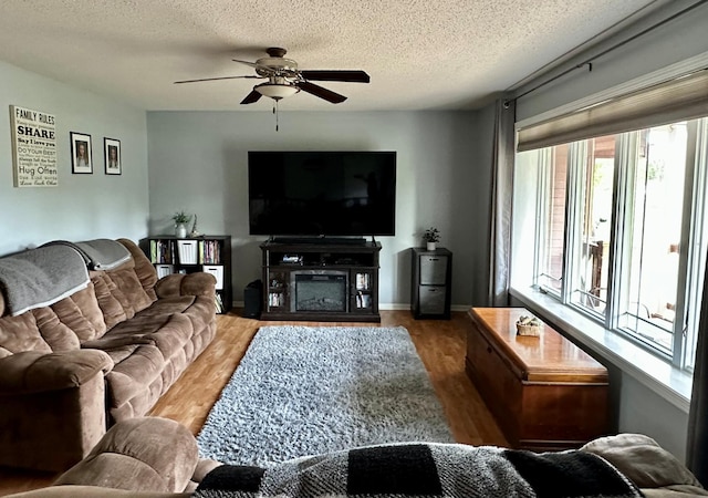 9808 Jenny Ln, Saint Wendel Twp, MN 56374 - living area with wood finished floors, a ceiling fan, a textured ceiling, and baseboards
