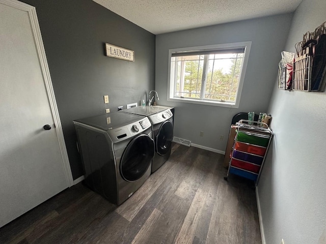 9808 Jenny Ln, Saint Wendel Twp, MN 56374 - washroom featuring washer and clothes dryer, dark wood-style floors, a textured ceiling, and baseboards