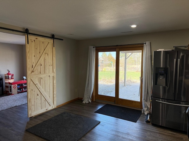 9808 Jenny Ln, Saint Wendel Twp, MN 56374 - entryway featuring a barn door, wood finished floors, recessed lighting, and baseboards
