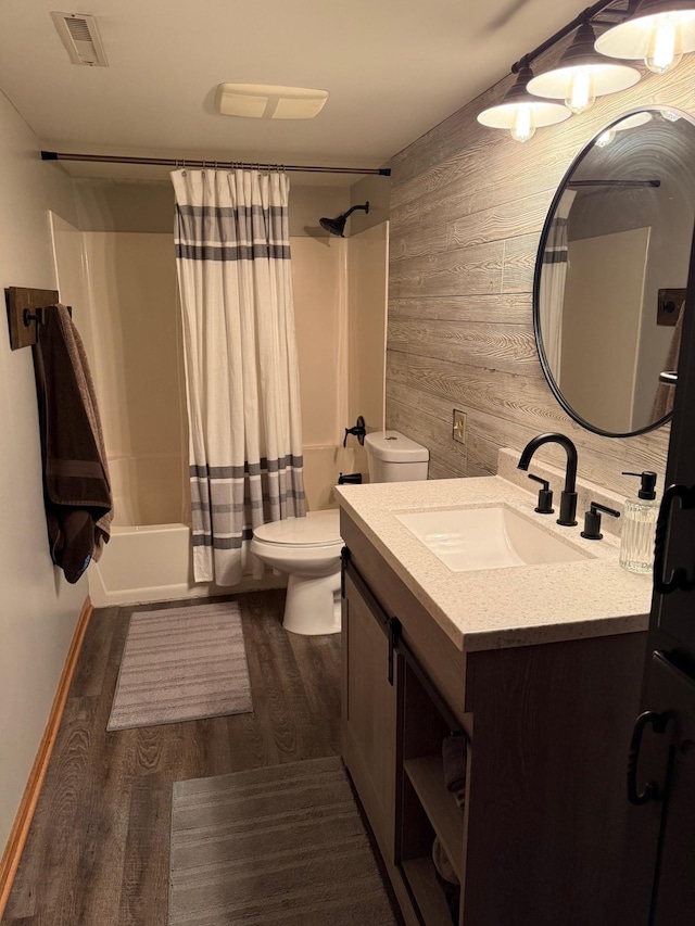 9808 Jenny Ln, Saint Wendel Twp, MN 56374 - full bath featuring wooden walls, wood finished floors, vanity, toilet, and shower / bathtub combination with curtain