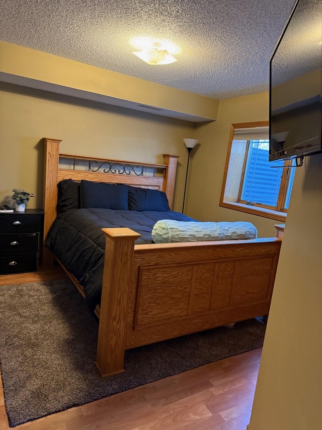 9808 Jenny Ln, Saint Wendel Twp, MN 56374 - bedroom featuring wood finished floors and a textured ceiling