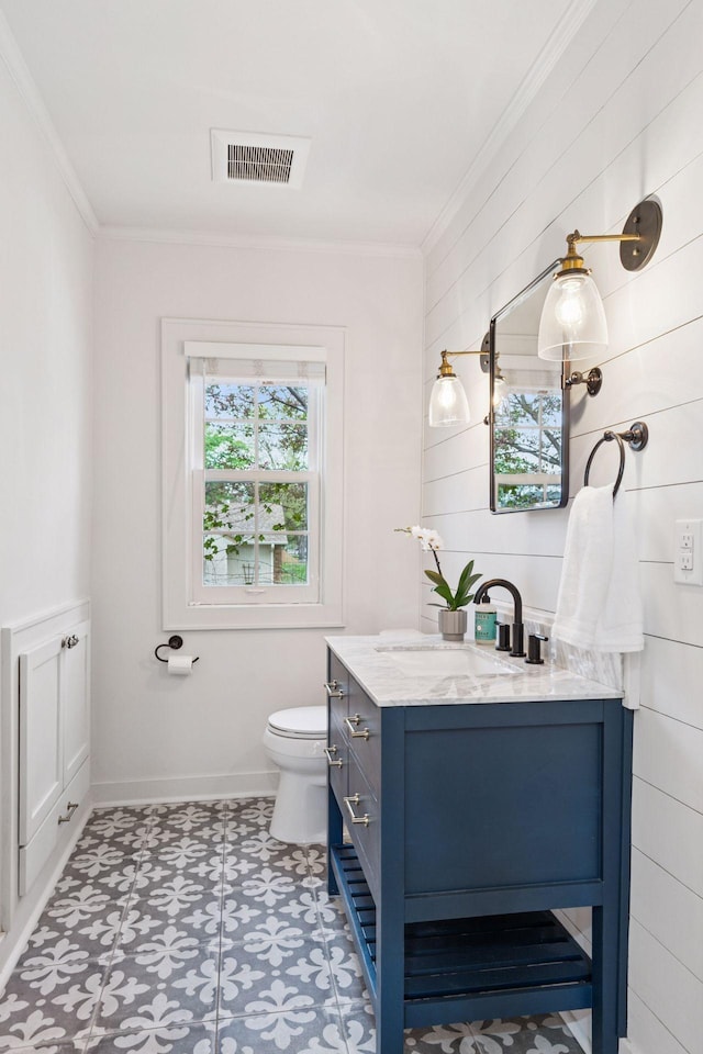bathroom with ornamental molding, vanity, tile patterned floors, toilet, and baseboards