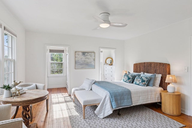 bedroom with wood finished floors, baseboards, and ceiling fan