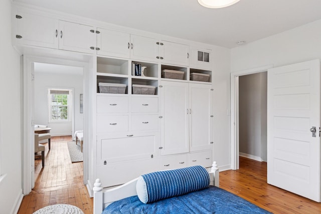 mudroom with light wood finished floors and baseboards