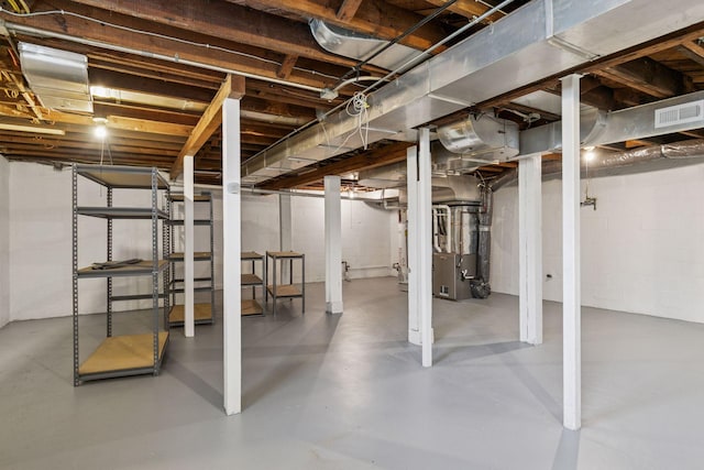 unfinished below grade area featuring heating unit