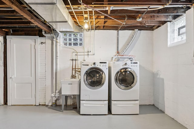clothes washing area featuring separate washer and dryer