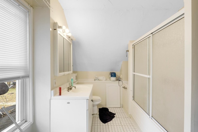 850 22nd Ave SE, Minneapolis, MN 55414 - bathroom with vaulted ceiling, vanity, enclosed tub / shower combo, and toilet