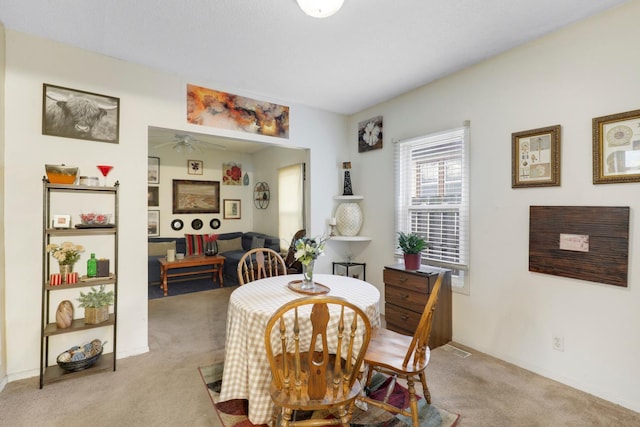 850 22nd Ave SE, Minneapolis, MN 55414 - dining room featuring baseboards, light colored carpet, and ceiling fan