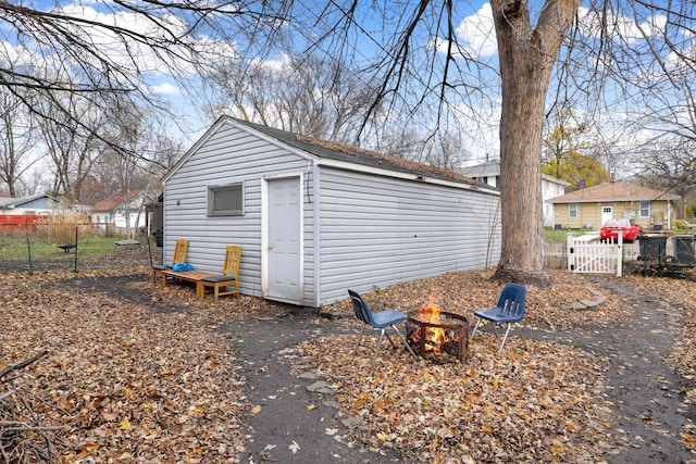850 22nd Ave SE, Minneapolis, MN 55414 - view of outbuilding featuring an outdoor structure, an outdoor fire pit, and fence