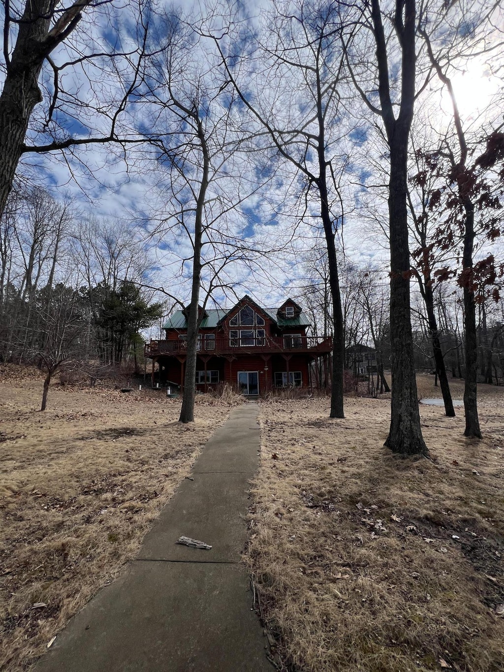 view of front of property featuring a wooden deck and driveway