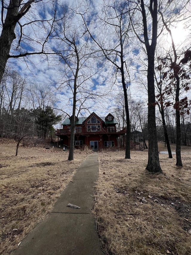 view of front of property featuring a wooden deck and driveway