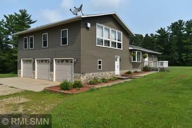 32255 County 21, Browerville, MN 56438 - back of house featuring a garage, driveway, and a yard