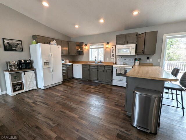 32255 County 21, Browerville, MN 56438 - kitchen featuring white appliances, a peninsula, gray cabinetry, dark wood finished floors, and lofted ceiling