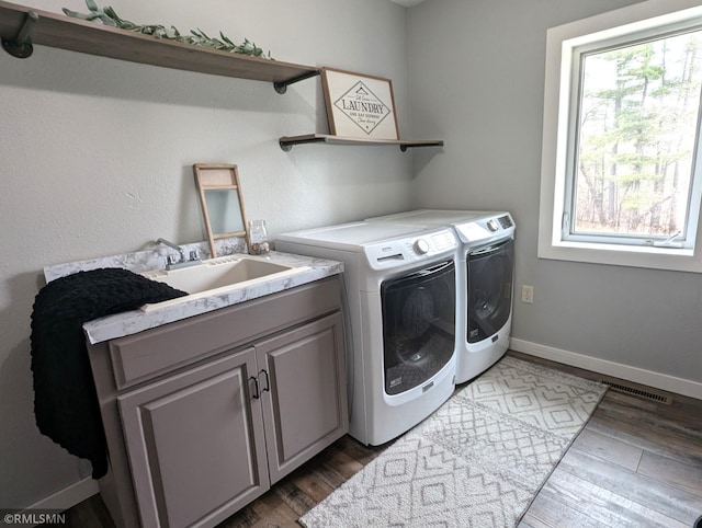 32255 County 21, Browerville, MN 56438 - clothes washing area with washer and dryer, wood finished floors, cabinet space, and baseboards