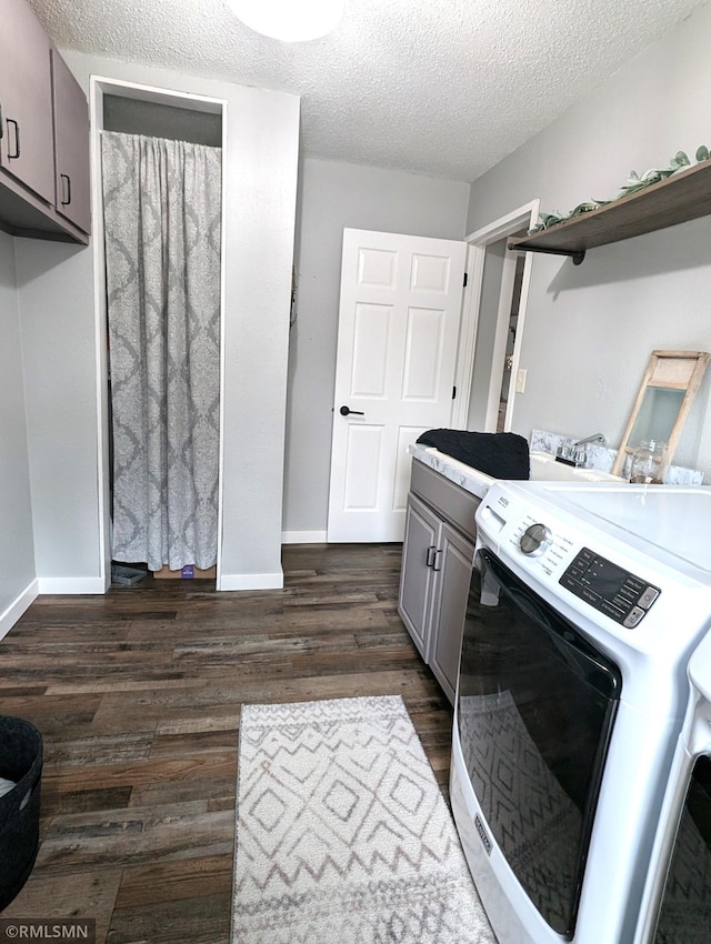 32255 County 21, Browerville, MN 56438 - washroom with washer / clothes dryer, cabinet space, dark wood-type flooring, baseboards, and a textured ceiling
