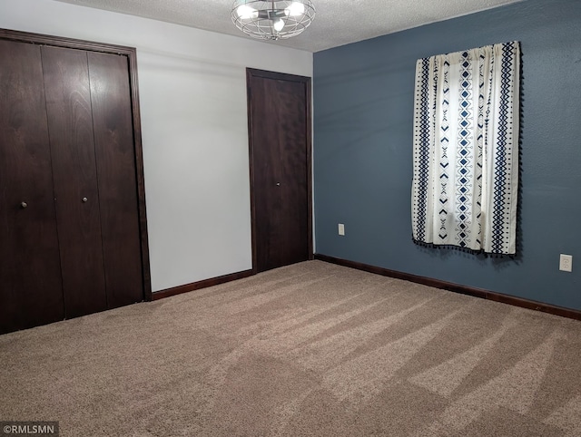 32255 County 21, Browerville, MN 56438 - unfurnished bedroom with carpet, two closets, baseboards, and a textured ceiling