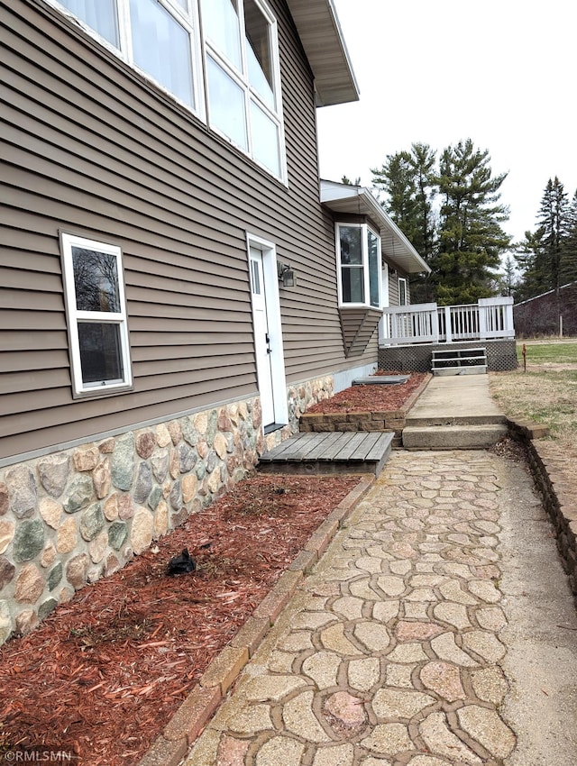32255 County 21, Browerville, MN 56438 - view of side of home with a deck and stone siding