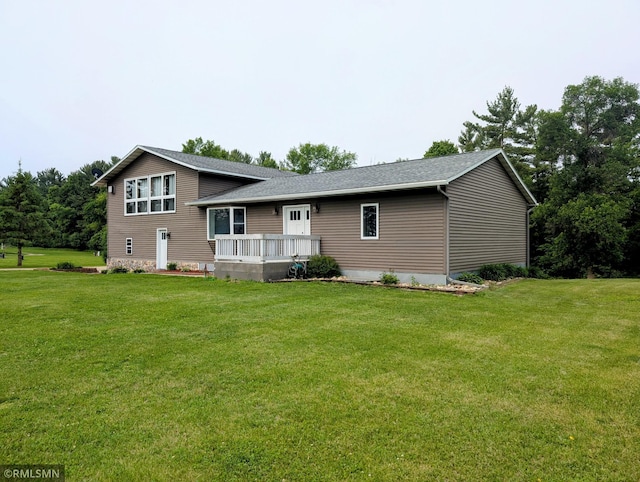 32255 County 21, Browerville, MN 56438 - view of front of property with a wooden deck, a front lawn, and a shingled roof