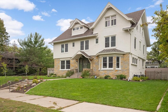 1647 26th St, Minneapolis, MN 55405 - view of front of house featuring stucco siding, stone siding, roof with shingles, and a standing seam roof