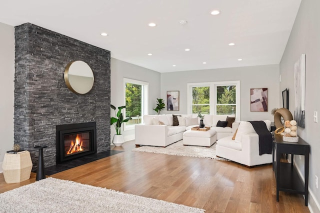 1647 26th St, Minneapolis, MN 55405 - living area with wood finished floors, a stone fireplace, and recessed lighting