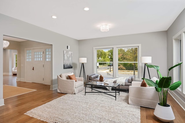 1647 26th St, Minneapolis, MN 55405 - living room with wood finished floors, baseboards, recessed lighting, and a chandelier