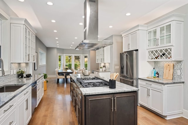 1647 26th St, Minneapolis, MN 55405 - kitchen with appliances with stainless steel finishes, island range hood, a sink, recessed lighting, and white cabinets
