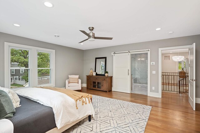 1647 26th St, Minneapolis, MN 55405 - bedroom featuring wood finished floors, recessed lighting, baseboards, a barn door, and ceiling fan