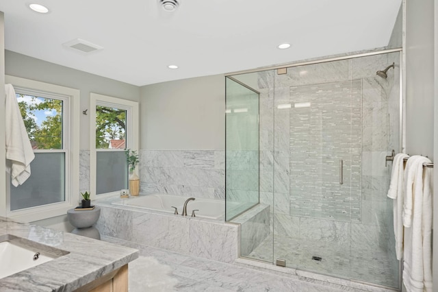 1647 26th St, Minneapolis, MN 55405 - full bathroom featuring a shower stall, a bath, recessed lighting, and vanity
