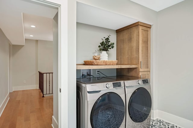 1647 26th St, Minneapolis, MN 55405 - washroom featuring separate washer and dryer, cabinet space, baseboards, light wood-type flooring, and recessed lighting
