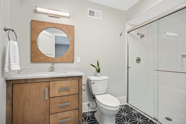 1647 26th St, Minneapolis, MN 55405 - full bath featuring a shower stall, toilet, vanity, and tile patterned floors