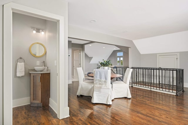 1647 26th St, Minneapolis, MN 55405 - sitting room with wood finished floors, vaulted ceiling, and baseboards