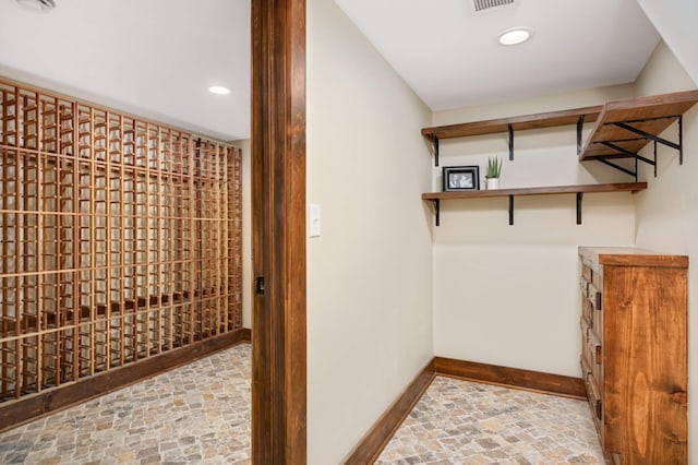 1647 26th St, Minneapolis, MN 55405 - wine room featuring baseboards, recessed lighting, and stone finish floors