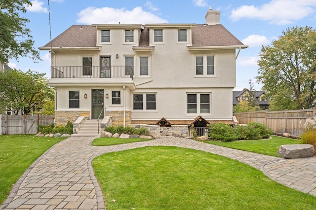 1647 26th St, Minneapolis, MN 55405 - back of house featuring a balcony, a chimney, stucco siding, and roof with shingles