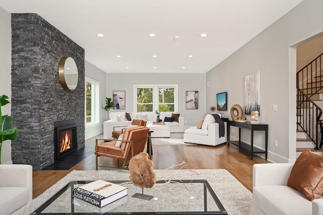 1647 26th St, Minneapolis, MN 55405 - living room with wood finished floors, stairway, a large fireplace, recessed lighting, and baseboards
