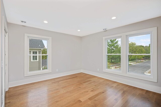 1647 26th St, Minneapolis, MN 55405 - spare room featuring light wood finished floors, baseboards, recessed lighting, and a smoke detector