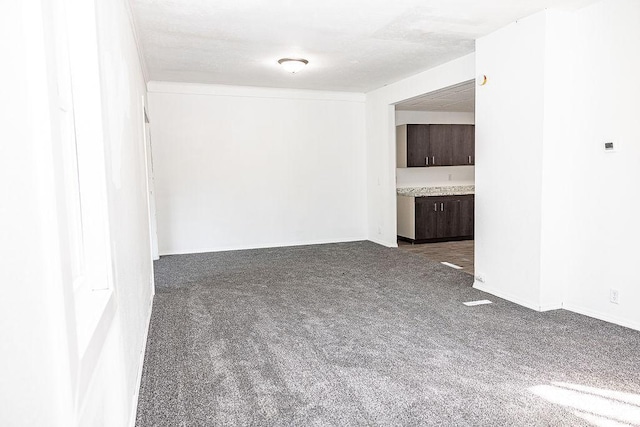 empty room featuring dark colored carpet