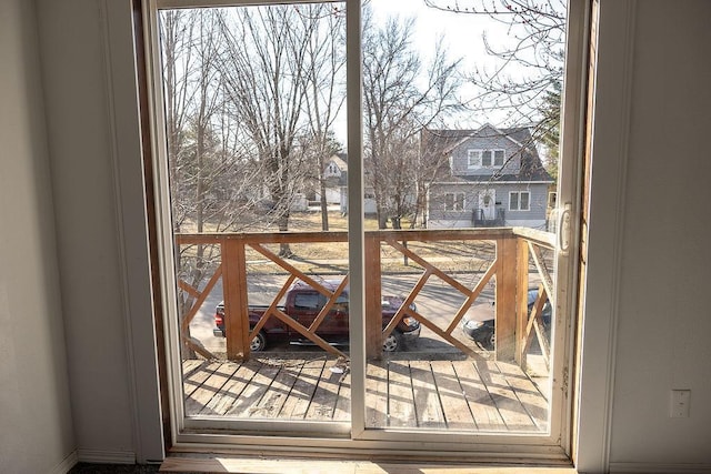 doorway featuring a residential view and baseboards