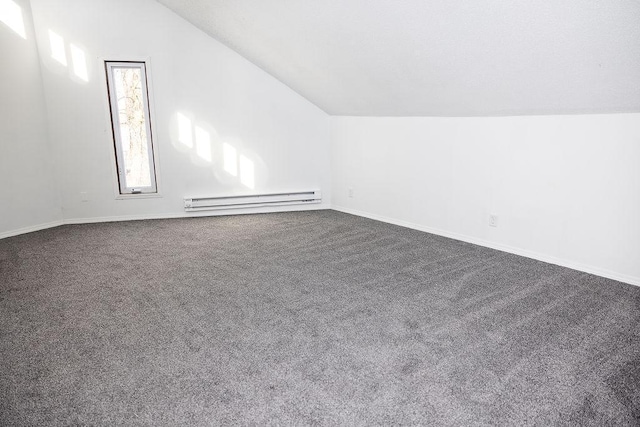 bonus room with baseboard heating, baseboards, vaulted ceiling, and dark colored carpet