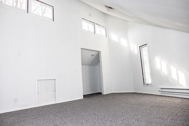 unfurnished room featuring baseboards, carpet floors, a textured ceiling, and high vaulted ceiling