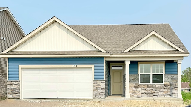 153 Snowdrop Trl, Waconia, MN 55387 - craftsman house featuring stone siding, roof with shingles, and a garage
